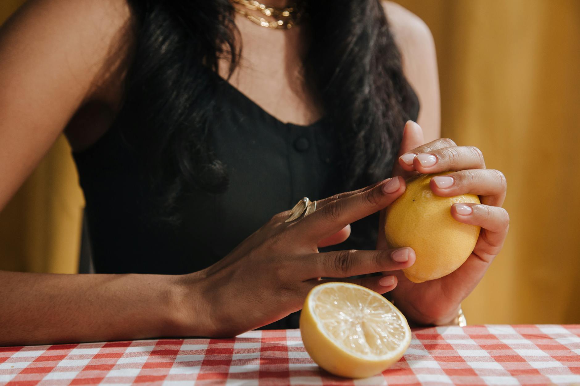 A woman holding fresh lemon, symbolizing renewal and gentle reconnection to pleasure