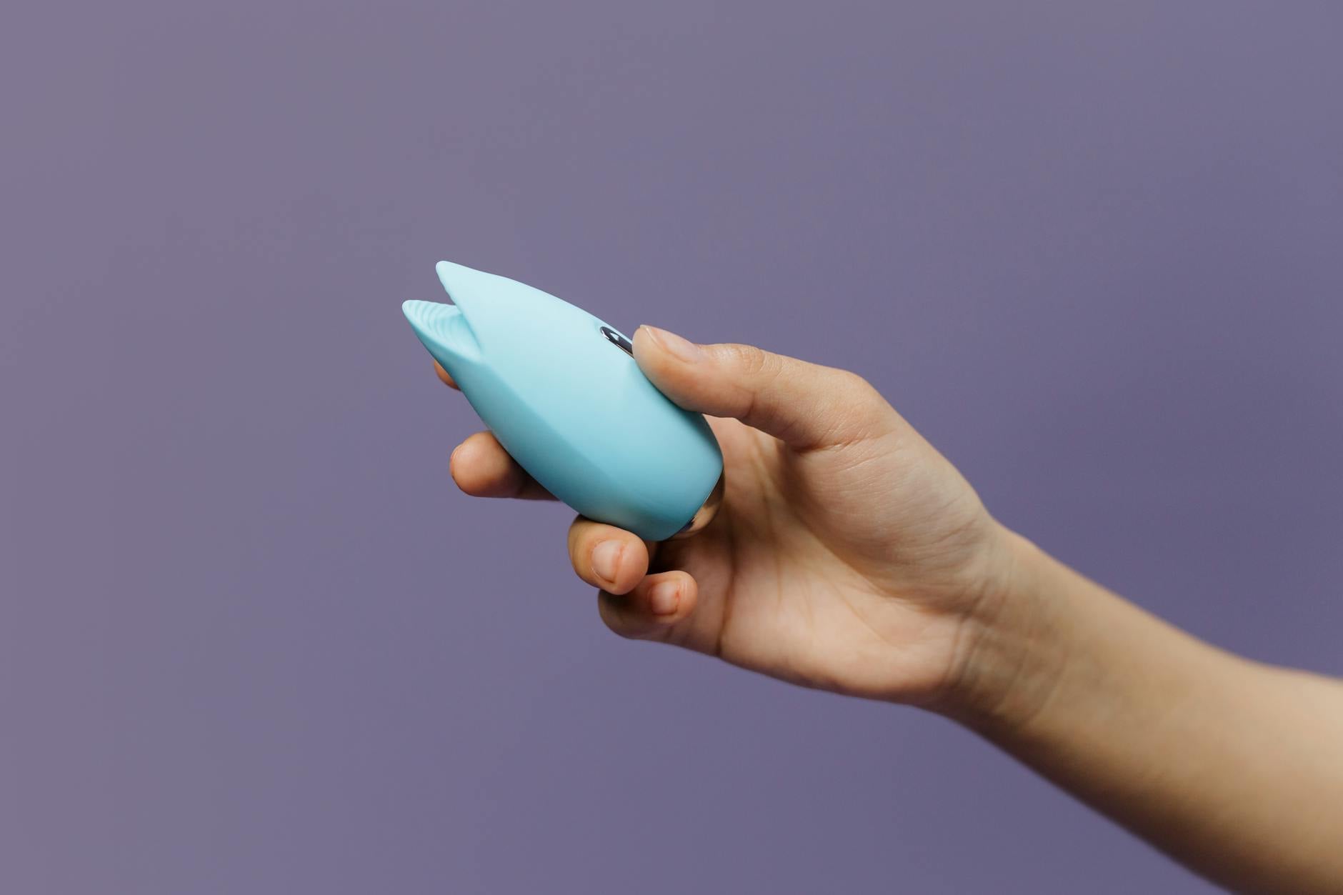 A silicone vibrator held in hand, symbolizing independence and personal pleasure within relationships.